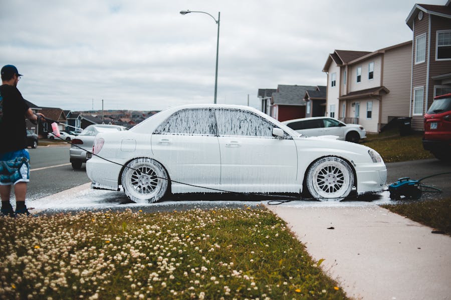 A real car covered in snow foam during an exterior wash